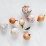 Onions and bulbs of garlic on a white background