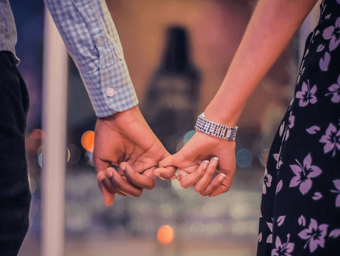 Couple holding hands.