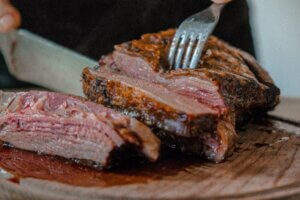 Cutting steak with knife and fork